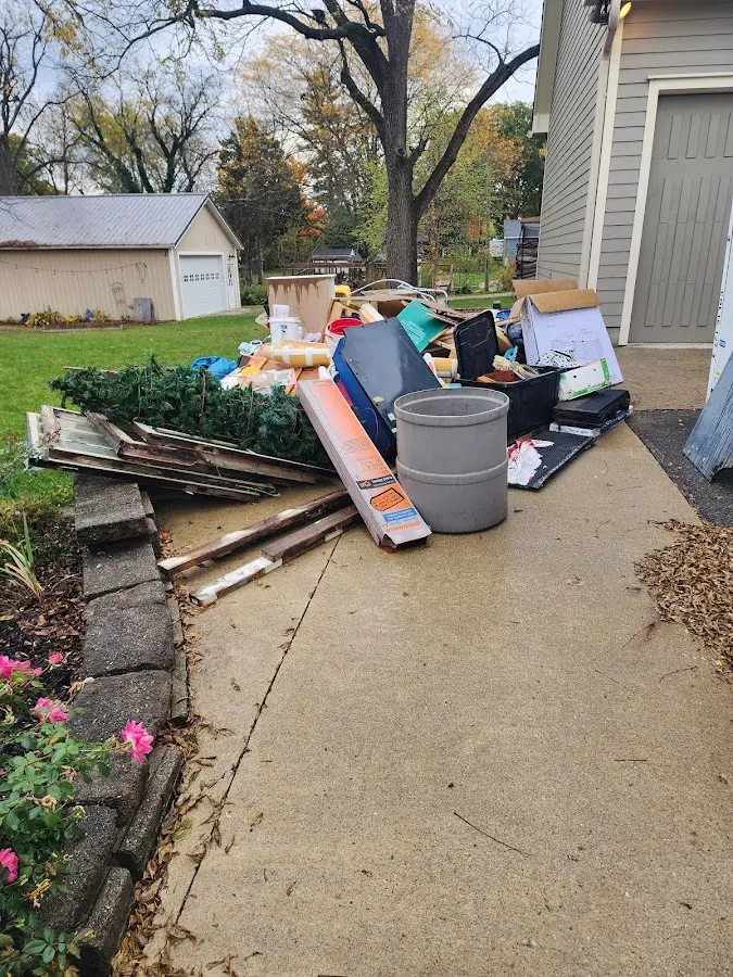 Dumpster being loaded with debris for 3 Yard Dumpster Rental in Newfield